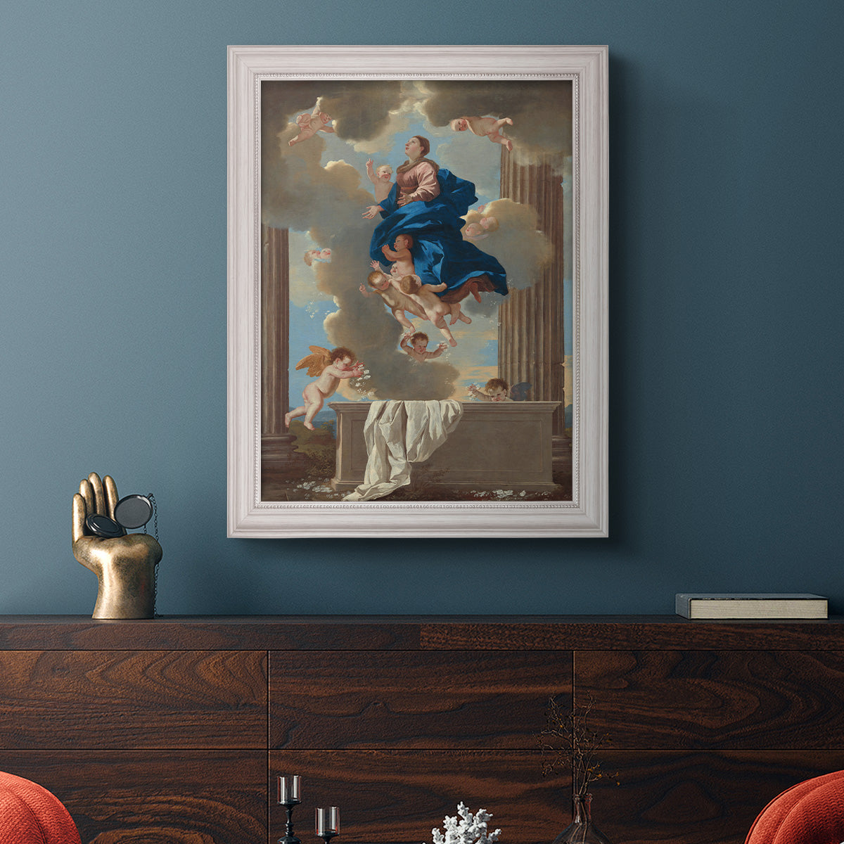 Classical religious depiction of the Assumption of the Virgin by Nicolas Poussin in an ornate weathered white frame displayed in a dark-toned interior setting.