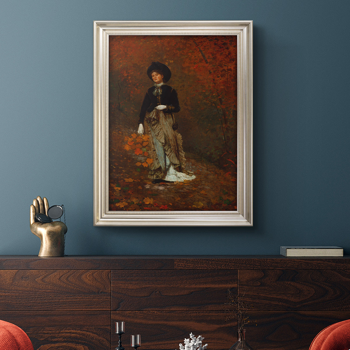Realist autumn portrait scene by Winslow Homer in an ornate champagne frame displayed in a dark-toned interior setting.