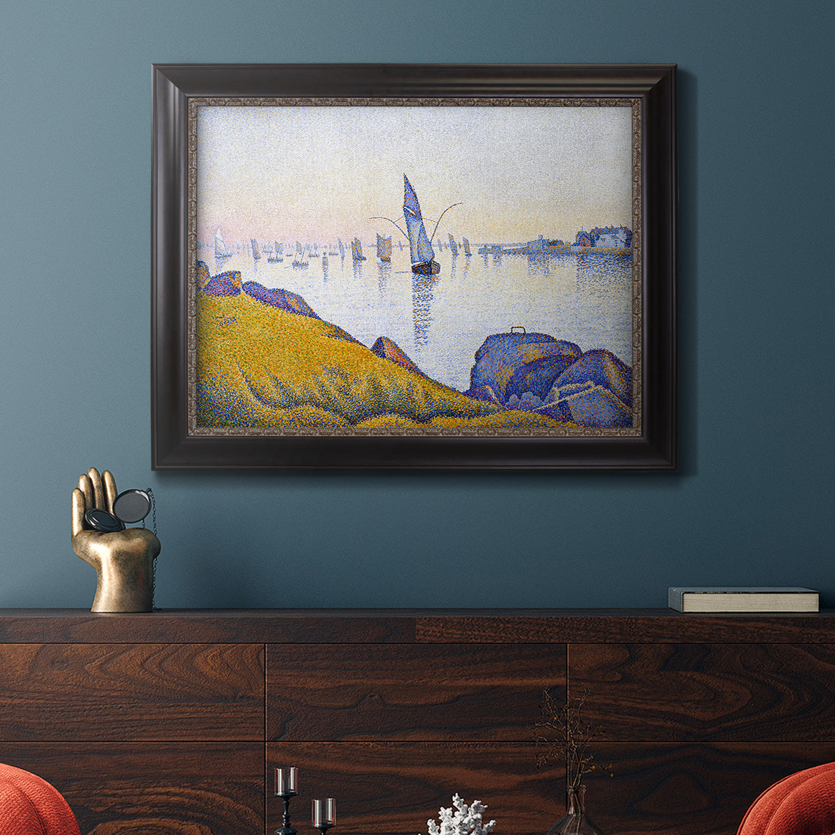Impressionist coastal harbor at dusk by Paul Signac in an ornate black frame with gilded inner detail displayed in a dark-toned interior setting.