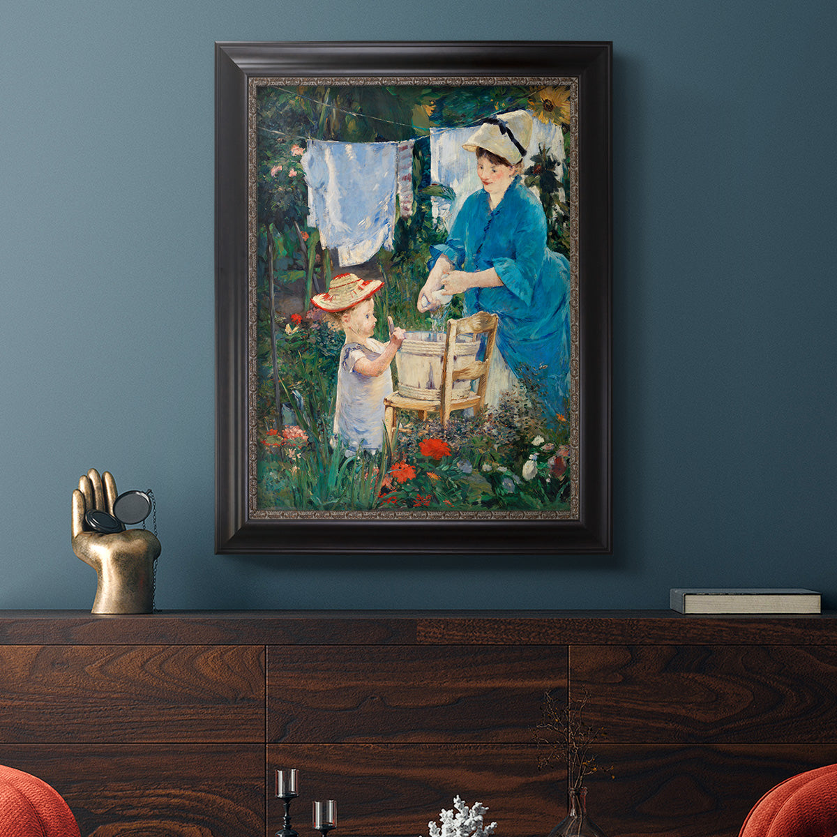 Intimate domestic genre scene by Édouard Manet in an ornate black frame with gilded inner detail displayed in a dark-toned interior setting.