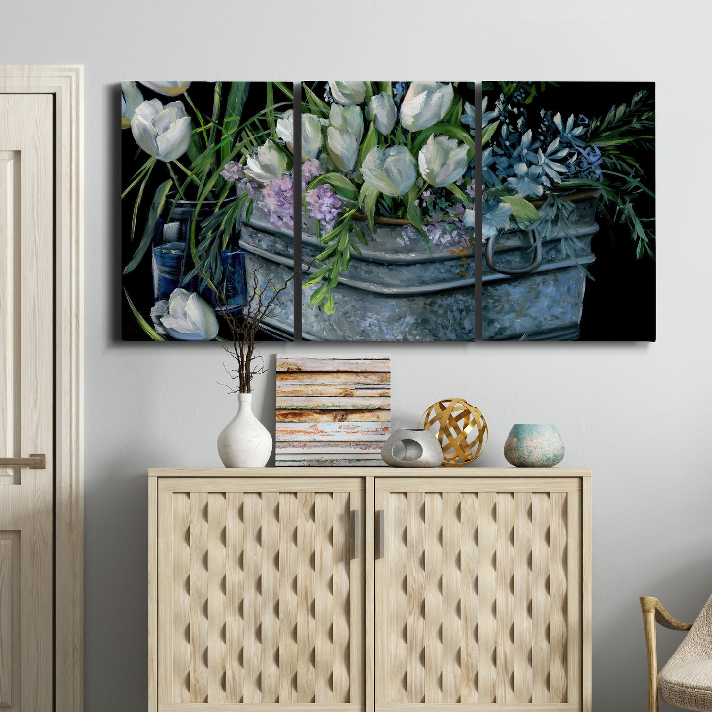 Three-panel canvas wall art featuring colorful wild tulips in bloom, displayed above a cabinet in an entryway.