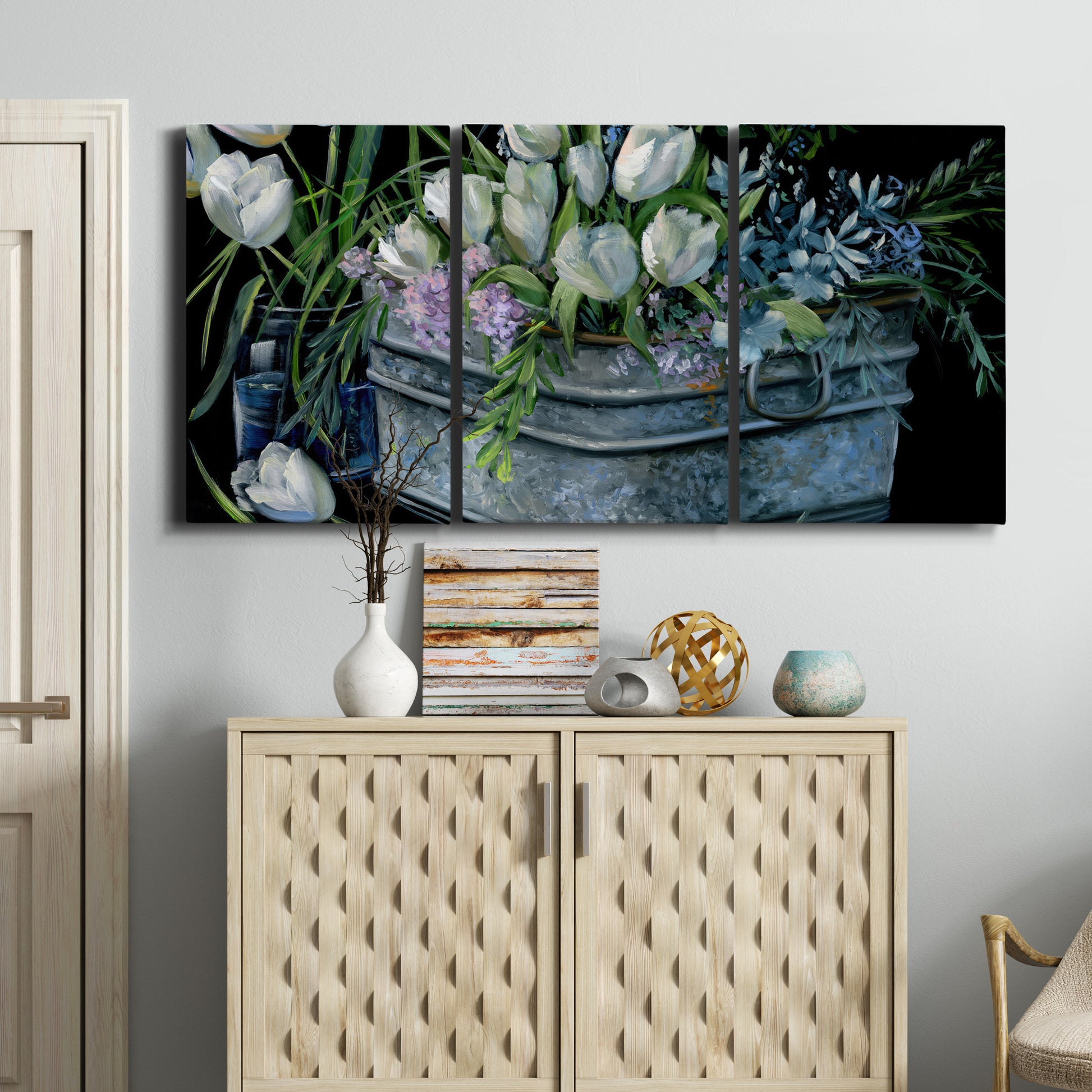 Three-panel canvas wall art featuring colorful wild tulips in bloom, displayed above a cabinet in an entryway.
