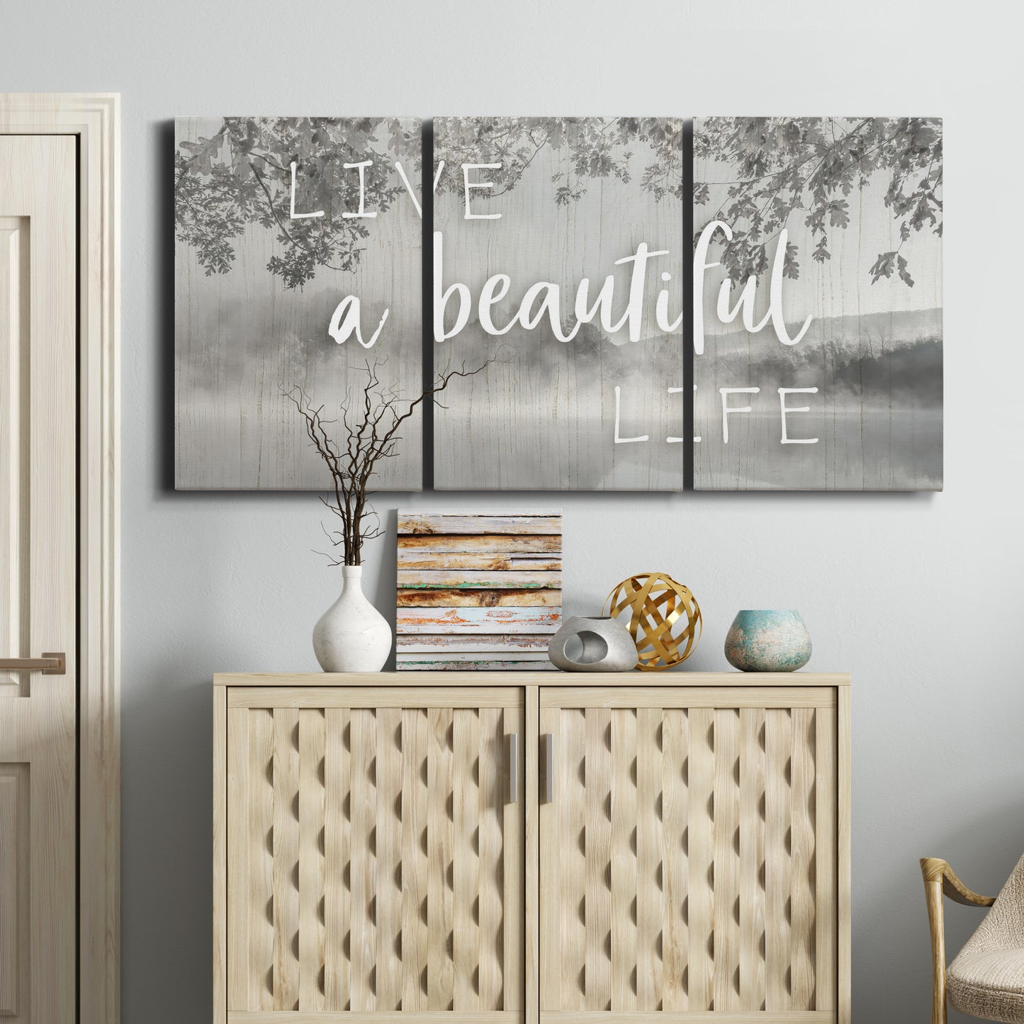 Three-panel canvas wall art featuring uplifting life themed typography, displayed above a cabinet in an entryway.