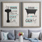 Set of two gray barnwood framed canvas prints depicting paired graphic bathroom word art with black tubs, hand-lettered phrases, and small teal accents above a sofa in a contemporary living room.