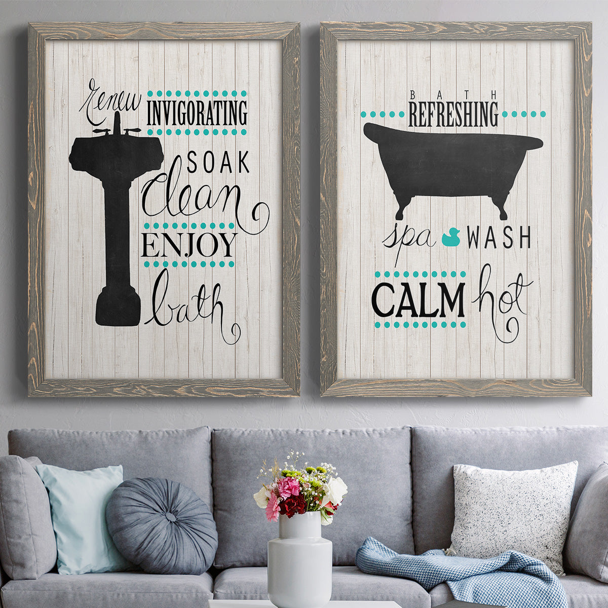 Set of two gray barnwood framed canvas prints depicting paired graphic bathroom word art with black tubs, hand-lettered phrases, and small teal accents above a sofa in a contemporary living room.