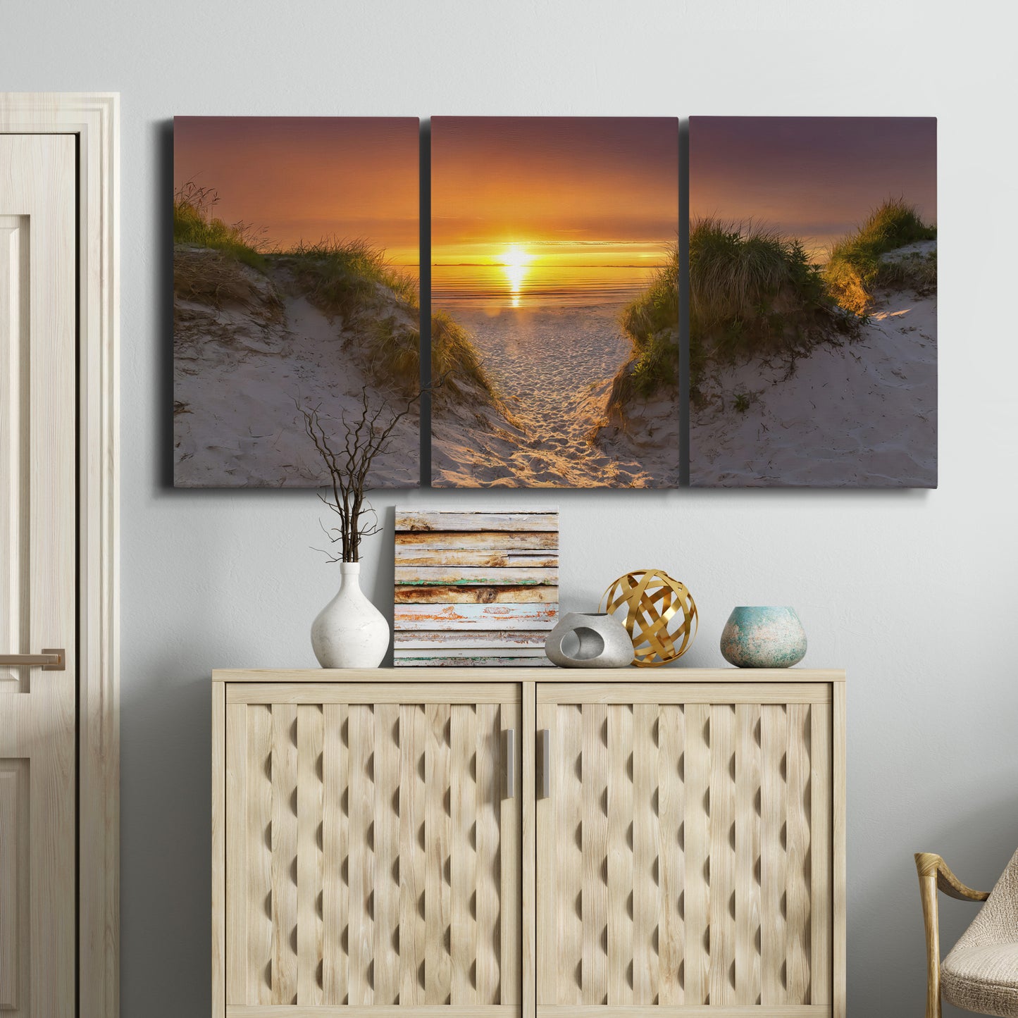 Three-panel canvas wall art featuring sunlit tropical path through greenery, displayed above a cabinet in an entryway.