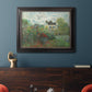 Impressionist garden landscape at Argenteuil by Claude Monet in an ornate black frame with gilded inner detail displayed in a dark-toned interior setting.