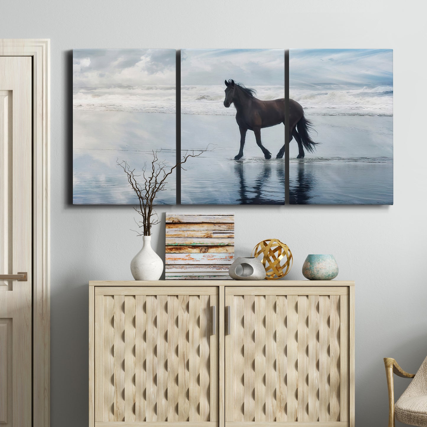 Three-panel canvas wall art featuring running horses captured mid stride, displayed above a cabinet in an entryway.