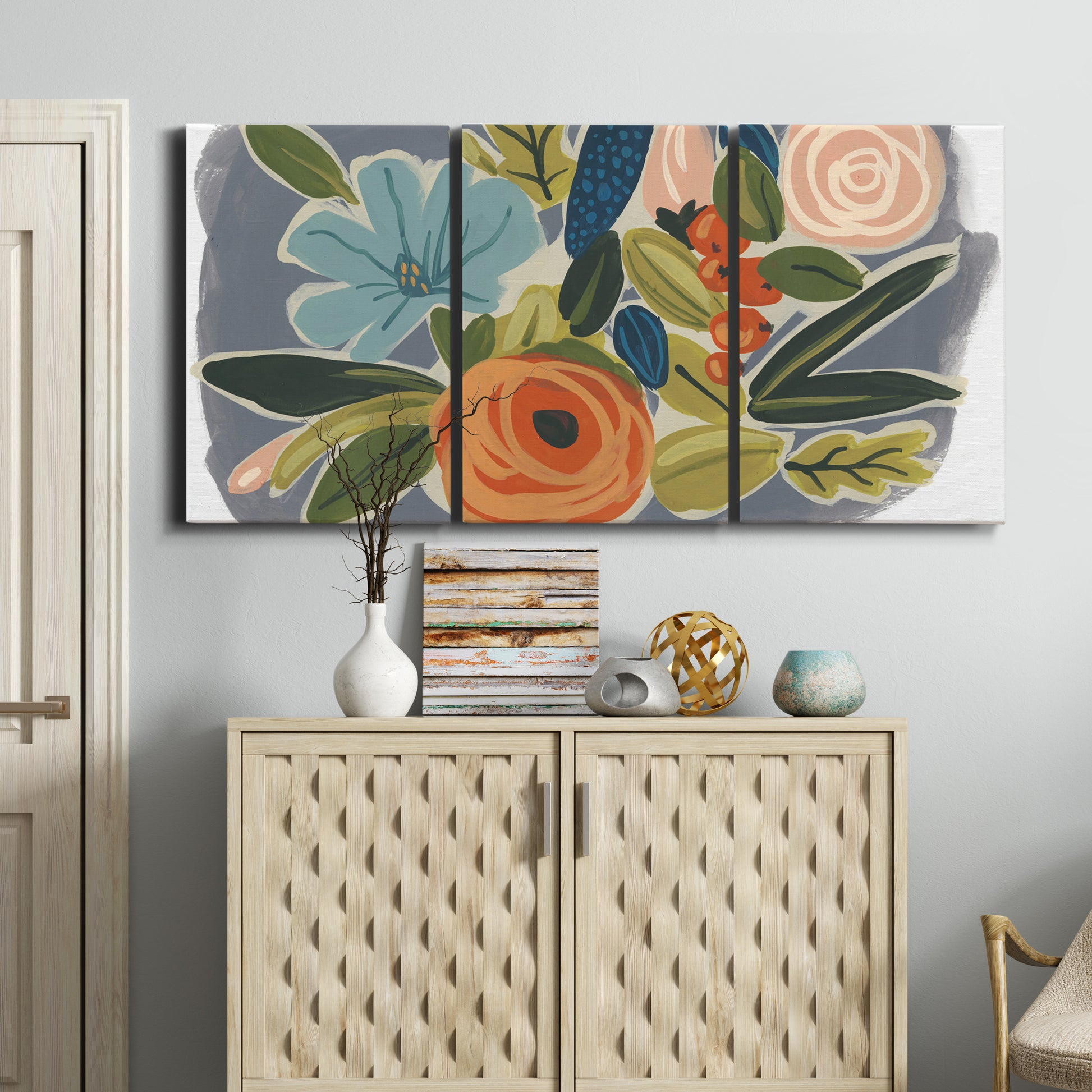 Three-panel canvas wall art featuring colorful botanical illustration, displayed above a cabinet in an entryway.