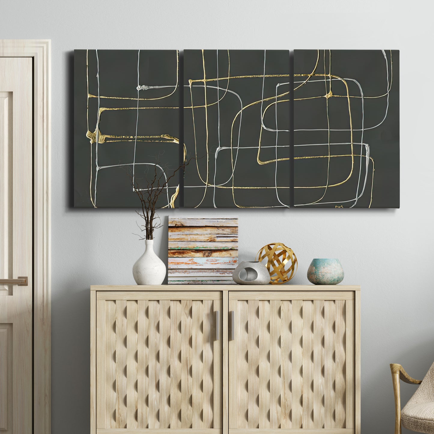 Three-panel canvas wall art featuring linear abstract conduit pattern, displayed above a cabinet in an entryway.