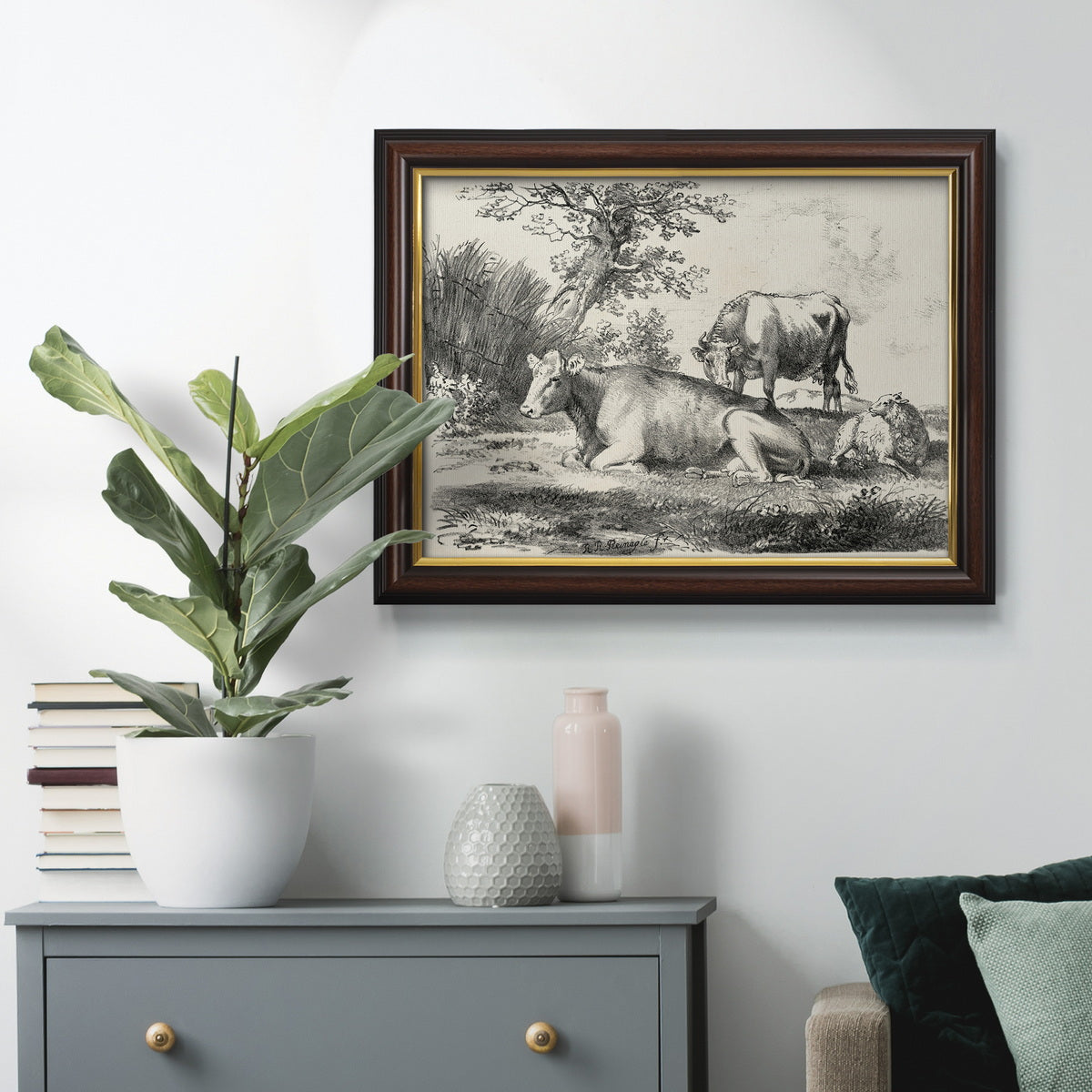 Classical pastoral landscape artwork by Nicolas Berchem in an ornate mahogany wood frame with gold liner displayed in a dark-toned interior setting.