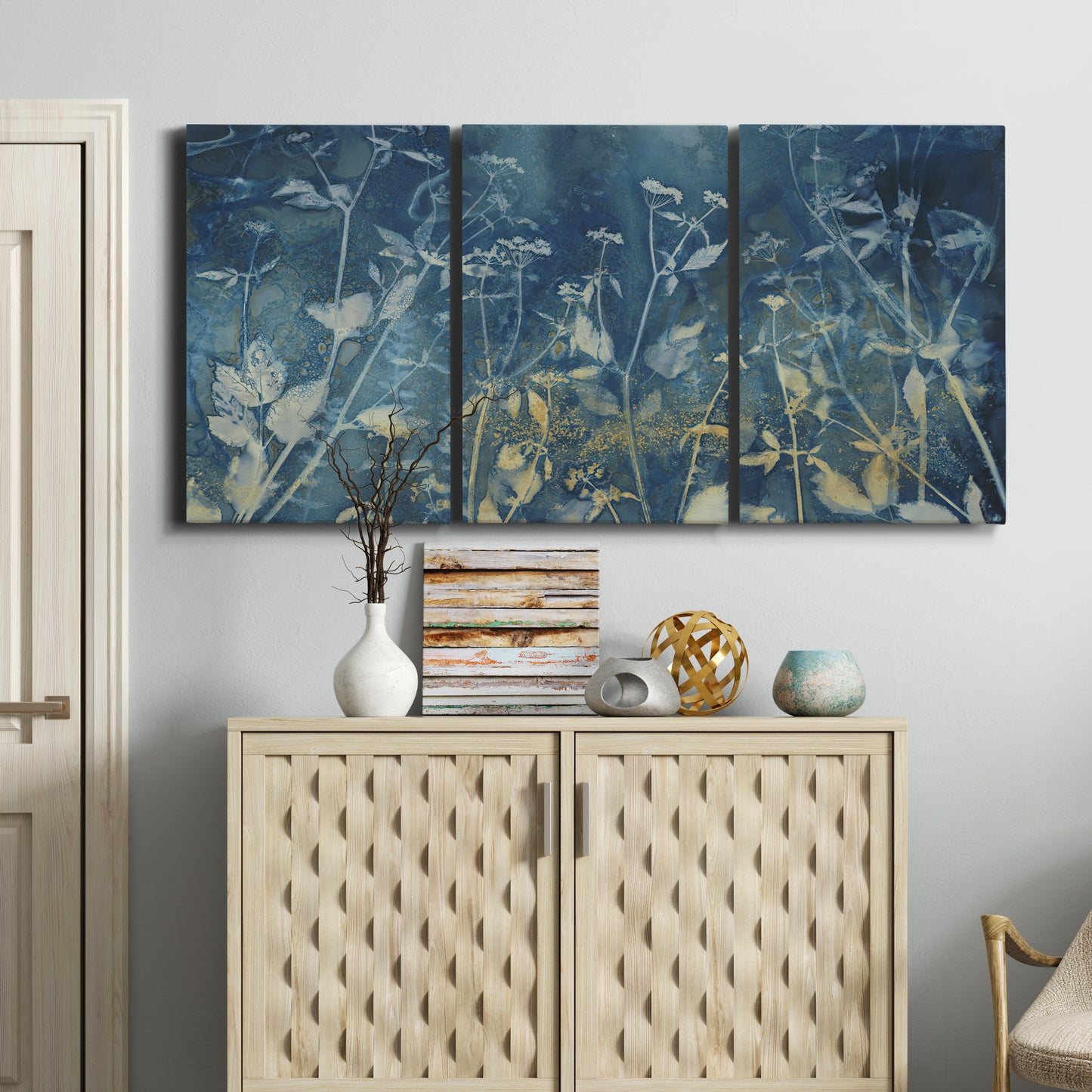 Three-panel canvas wall art featuring dark abstract with rich tonal depth, displayed above a cabinet in an entryway.