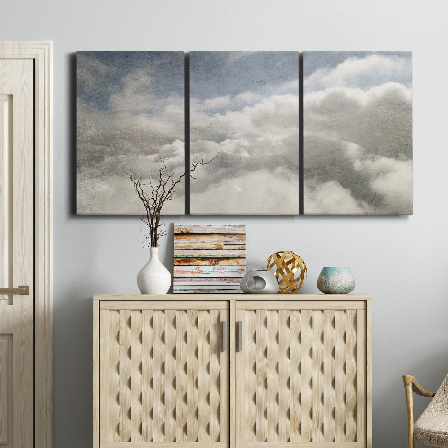 Three-panel canvas wall art featuring aerial landscape view photograph, displayed above a cabinet in an entryway.
