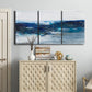 Three-panel canvas wall art featuring moody abstract sea with depth, displayed above a cabinet in an entryway.