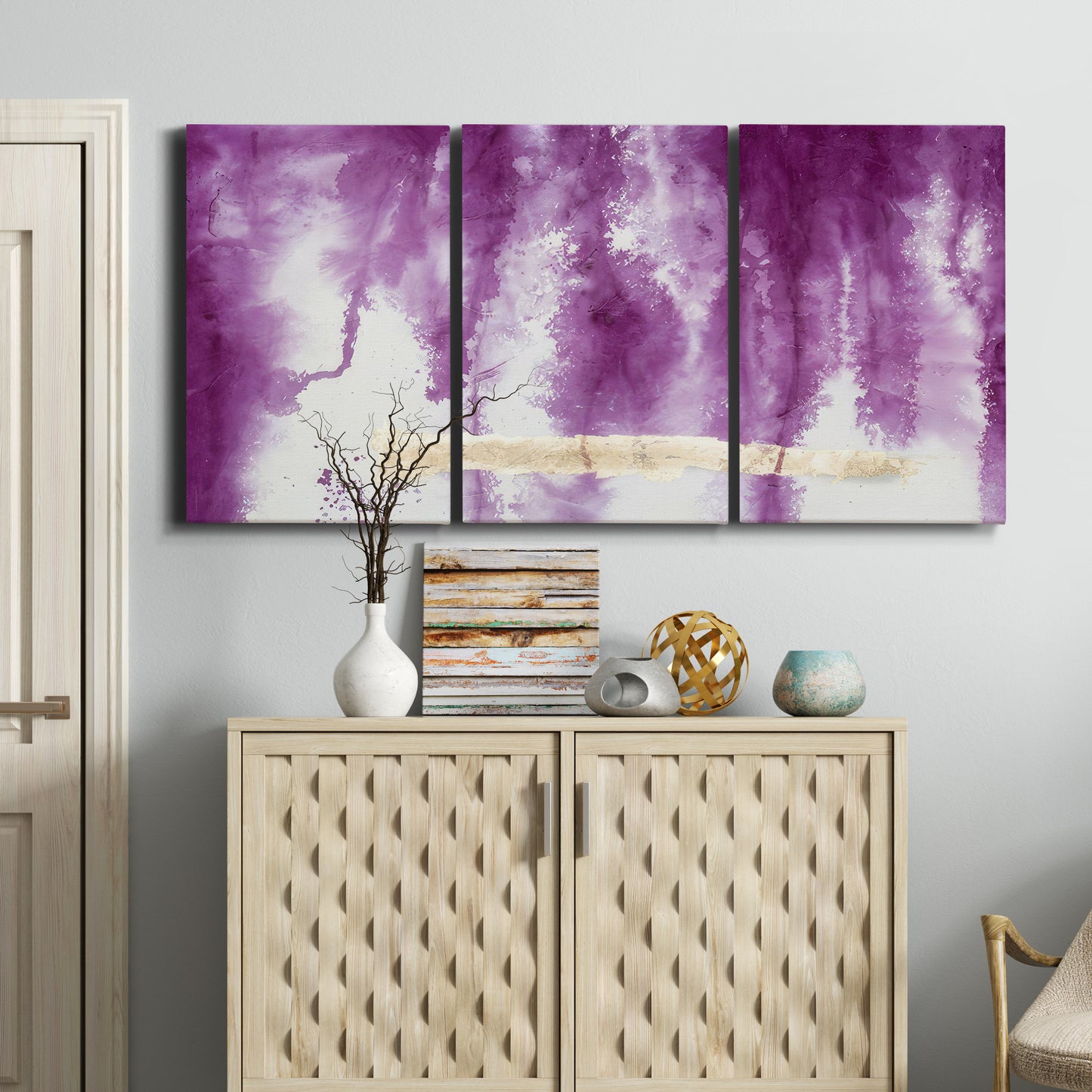 Three-panel canvas wall art featuring saturated abstract color fields, displayed above a cabinet in an entryway.