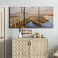 Three-panel canvas wall art featuring coastal path along dunes, displayed above a cabinet in an entryway.