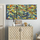 Three-panel canvas wall art featuring colorful abstract river like motion, displayed above a cabinet in an entryway.