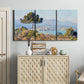 Three-panel canvas wall art featuring coastal town viewed from hillside, displayed above a cabinet in an entryway.