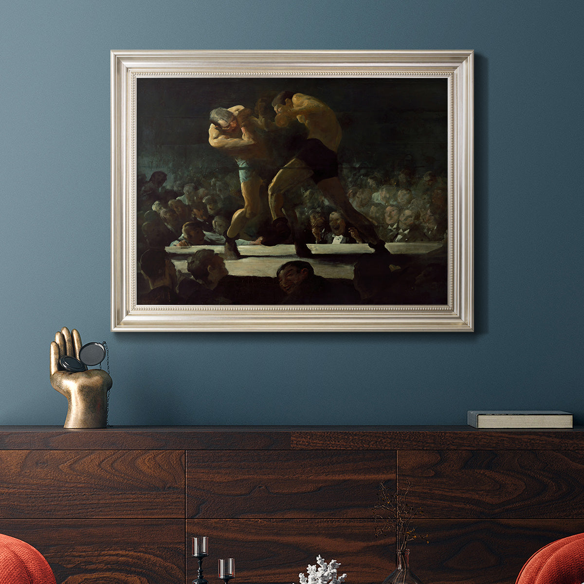 American social club scene painting by George Bellows in an ornate champagne frame displayed in a dark-toned interior setting.