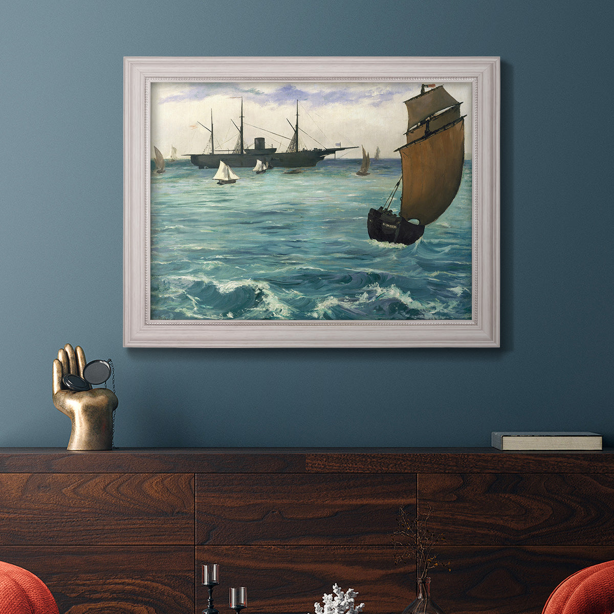 Impressionist naval seascape with the Kearsarge by Édouard Manet in an ornate weathered white frame displayed in a dark-toned interior setting.