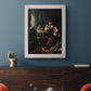 Classical portrait of a soldier smoking a pipe by Frans van Mieris the Elder in an ornate weathered white frame displayed in a dark-toned interior setting.