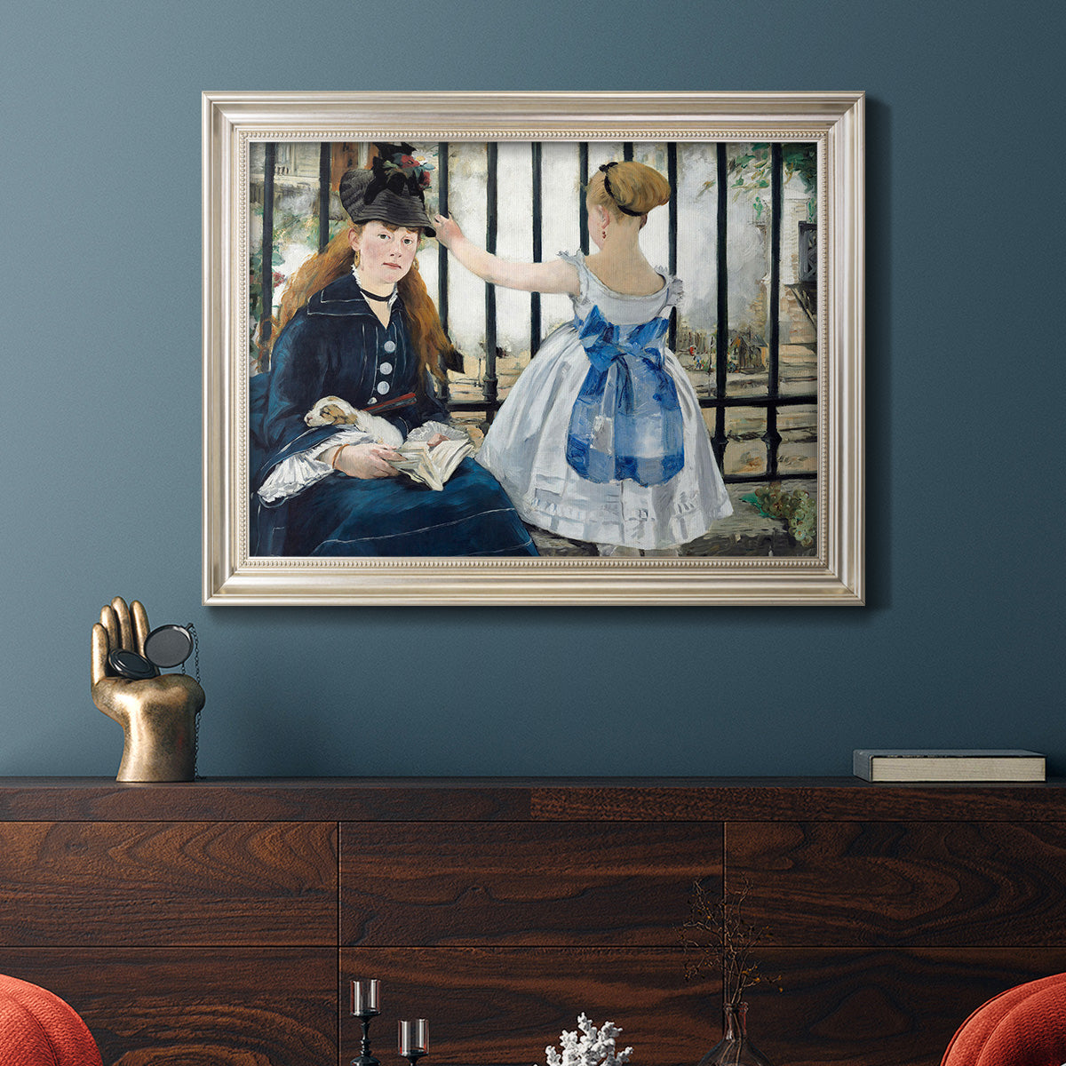 Impressionist urban scene near a railway by Édouard Manet in an ornate champagne frame displayed in a dark-toned interior setting.