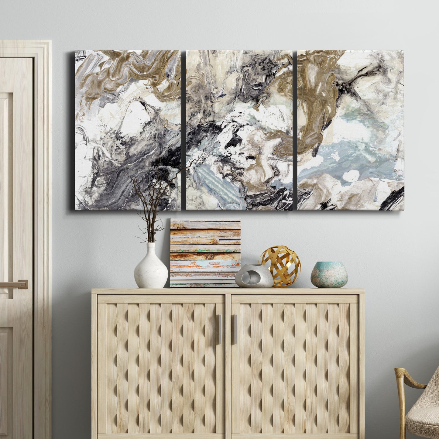 Three-panel canvas wall art featuring marbled modern abstract textures, displayed above a cabinet in an entryway.