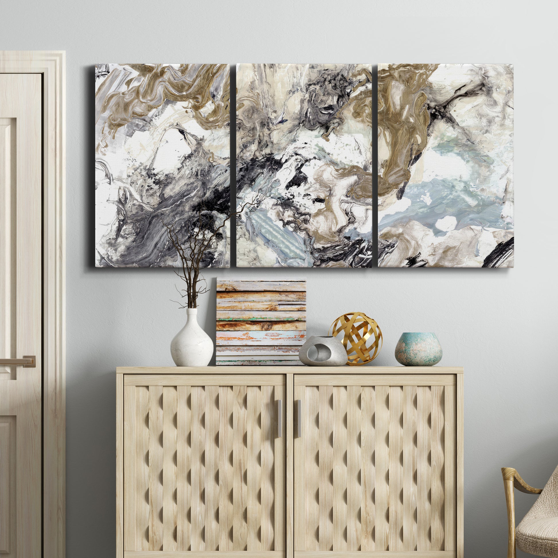 Three-panel canvas wall art featuring marbled modern abstract textures, displayed above a cabinet in an entryway.