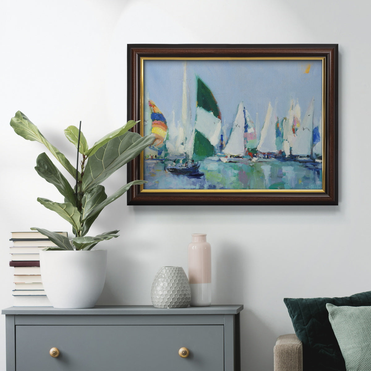 Coastal harbor watercolor painting in an ornate mahogany wood frame with gold liner displayed in a dark-toned interior setting.