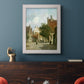 Rustic European street scene painting by Adriaan Eversen in an ornate weathered white frame displayed in a dark-toned interior setting.