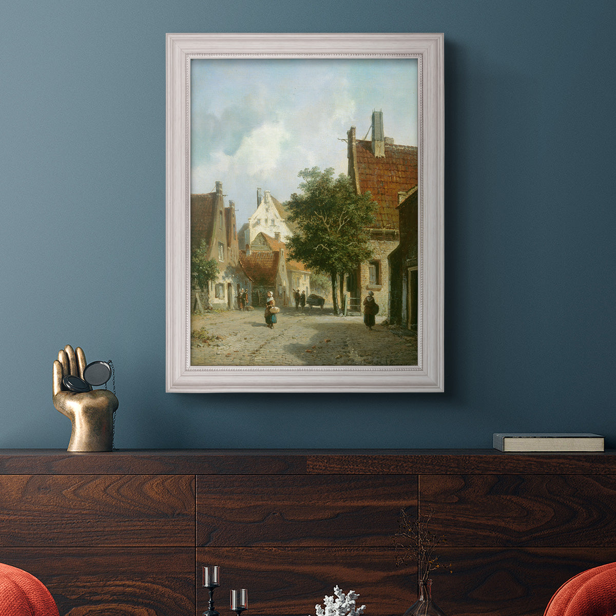 Rustic European street scene painting by Adriaan Eversen in an ornate weathered white frame displayed in a dark-toned interior setting.