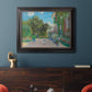 Impressionist residential landscape at Argenteuil by Claude Monet in an ornate black frame with gilded inner detail displayed in a dark-toned interior setting.
