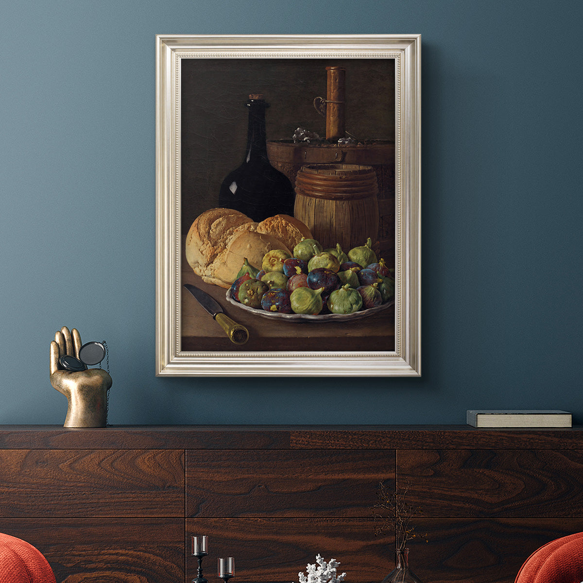 Realist still life with figs and bread by Luis Meléndez in an ornate champagne frame displayed in a dark-toned interior setting.