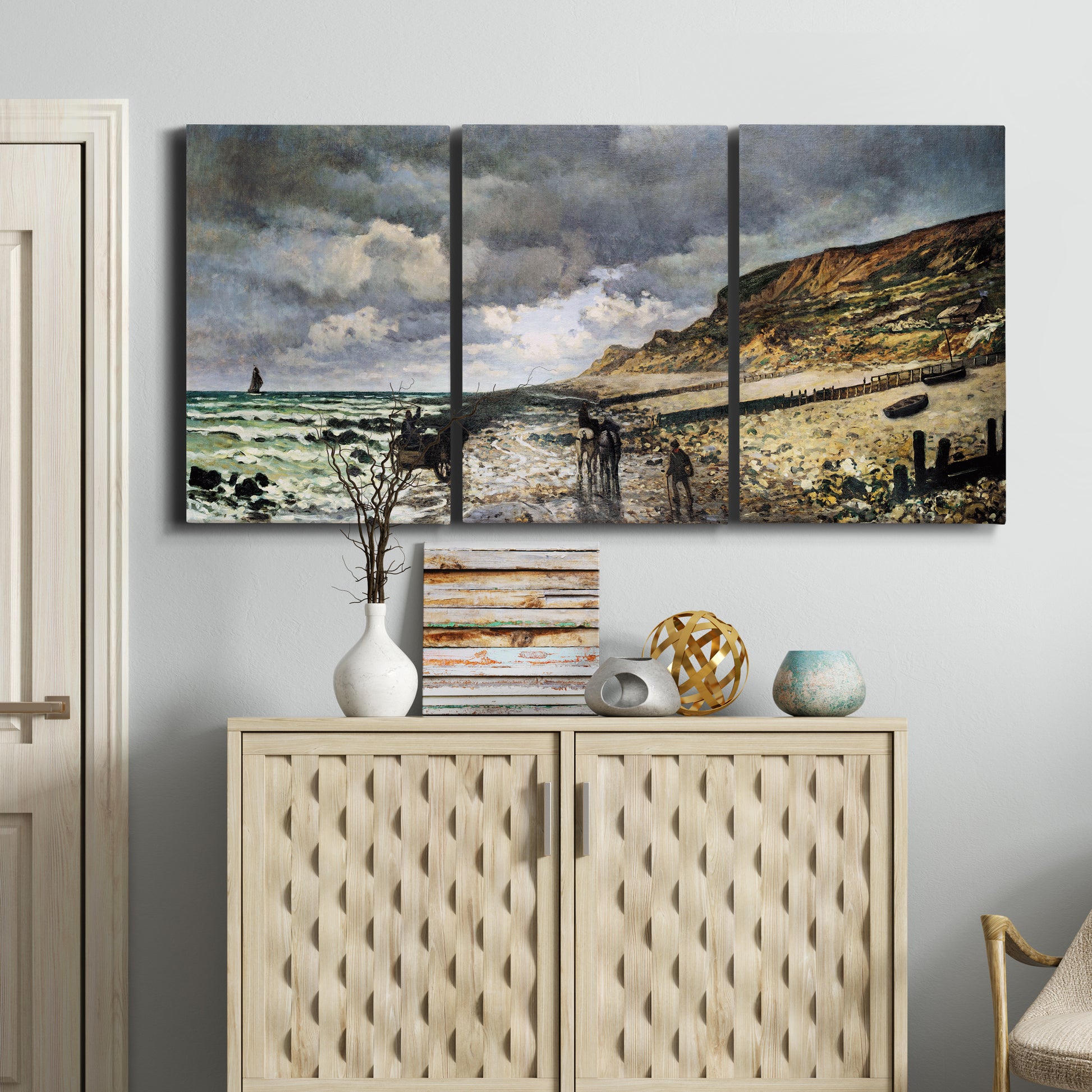 Three-panel canvas wall art featuring sunset beach with glowing sky, displayed above a cabinet in an entryway.
