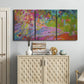 Three-panel canvas wall art featuring vibrant abstract with dramatic motion, displayed above a cabinet in an entryway.