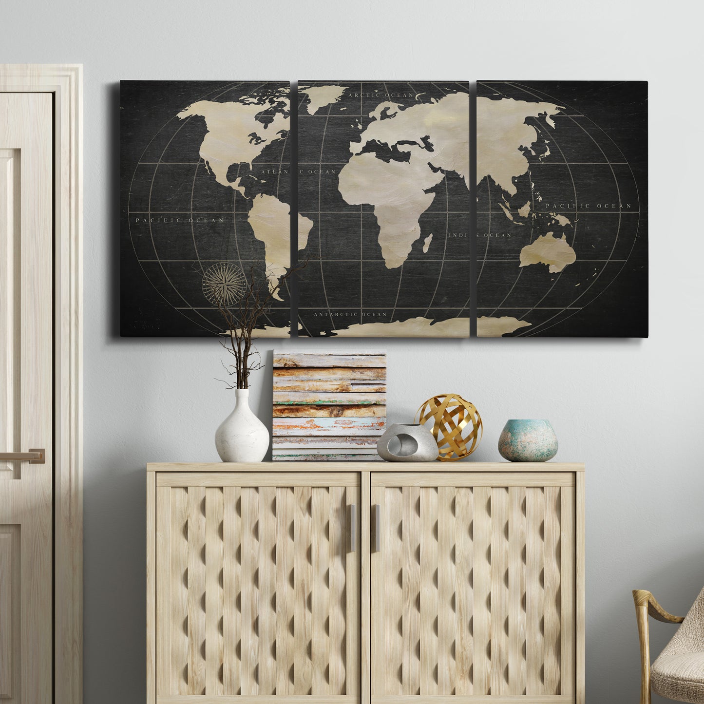 Three-panel canvas wall art featuring antique world map illustration, displayed above a cabinet in an entryway.