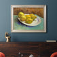 Impressionist still life with lemons by Vincent van Gogh in an ornate champagne frame displayed in a dark-toned interior setting.