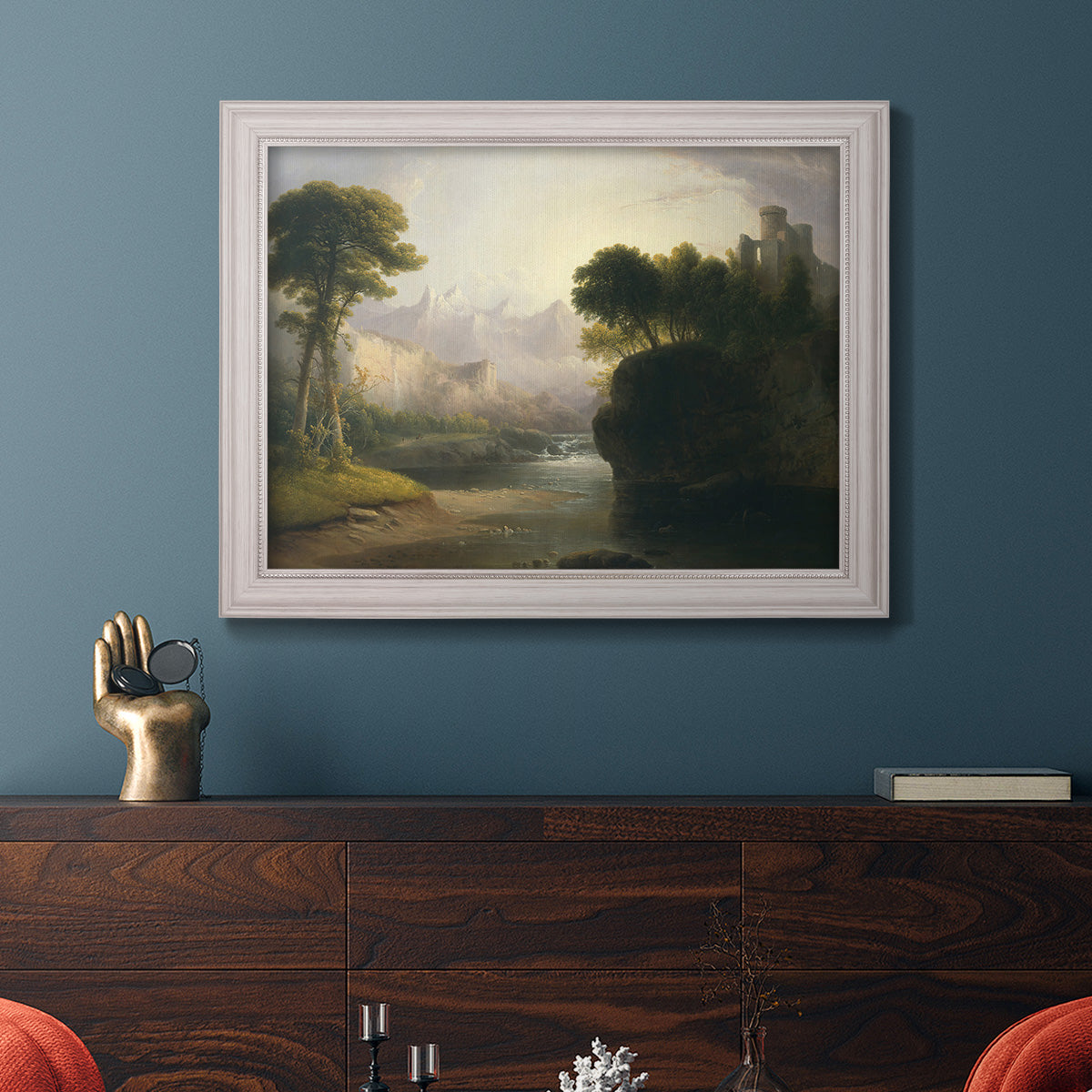 Romantic autumn landscape along the Hudson River by Thomas Doughty in an ornate weathered white frame displayed in a dark-toned interior setting.