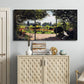 Three-panel canvas wall art featuring coastal garden overlooking sea, displayed above a cabinet in an entryway.