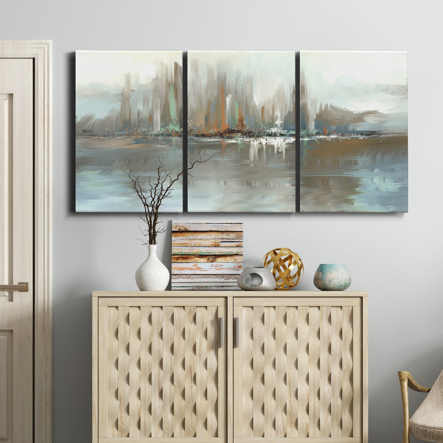 Three-panel canvas wall art featuring glowing abstract city lights, displayed above a cabinet in an entryway.