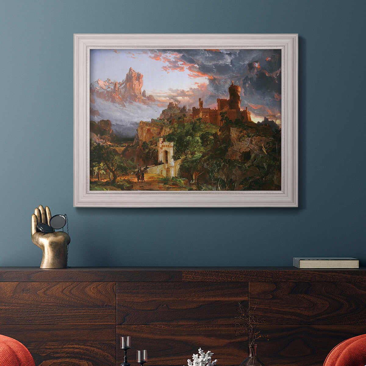 Romantic allegorical landscape painting by Jasper Francis Cropsey in an ornate weathered white frame displayed in a dark-toned interior setting.