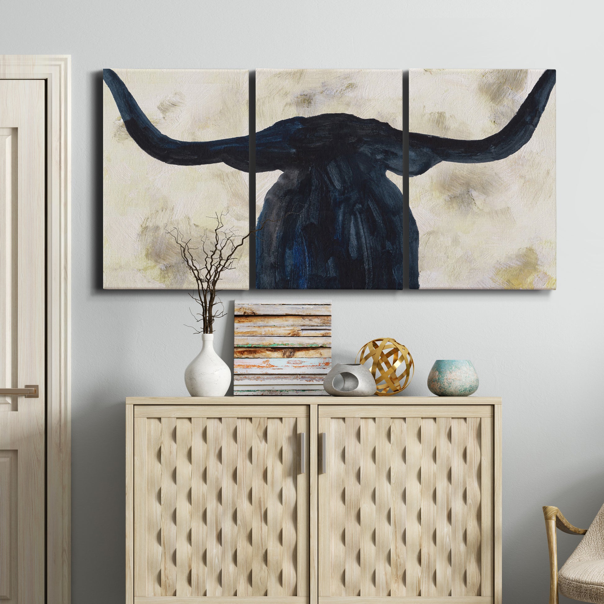 Three-panel canvas wall art featuring rustic animal portrait illustration, displayed above a cabinet in an entryway.