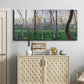 Three-panel canvas wall art featuring spring landscape along river, displayed above a cabinet in an entryway.