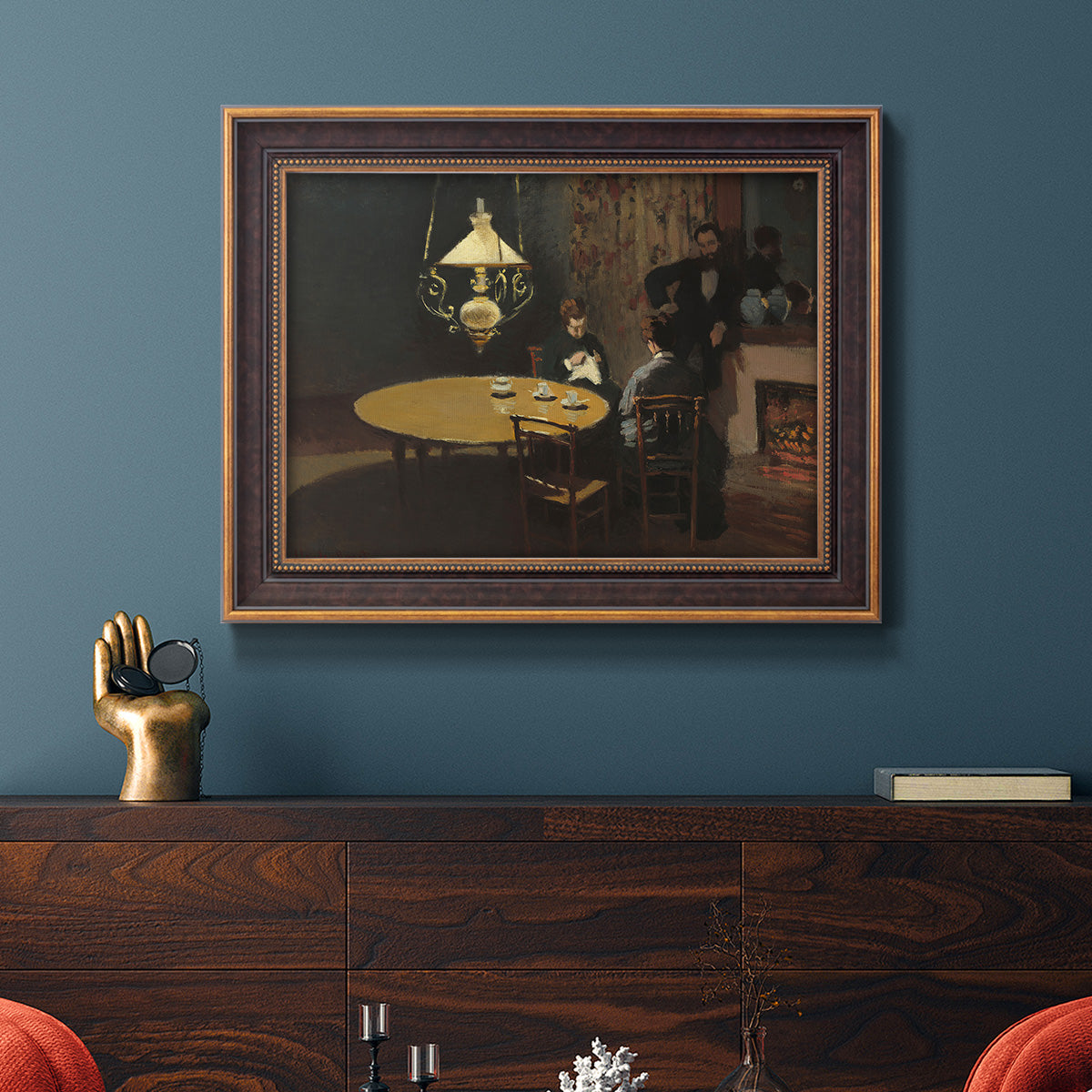 Impressionist domestic interior scene by Claude Monet in an ornate bronzed mahogany wood frame displayed in a dark-toned interior setting.