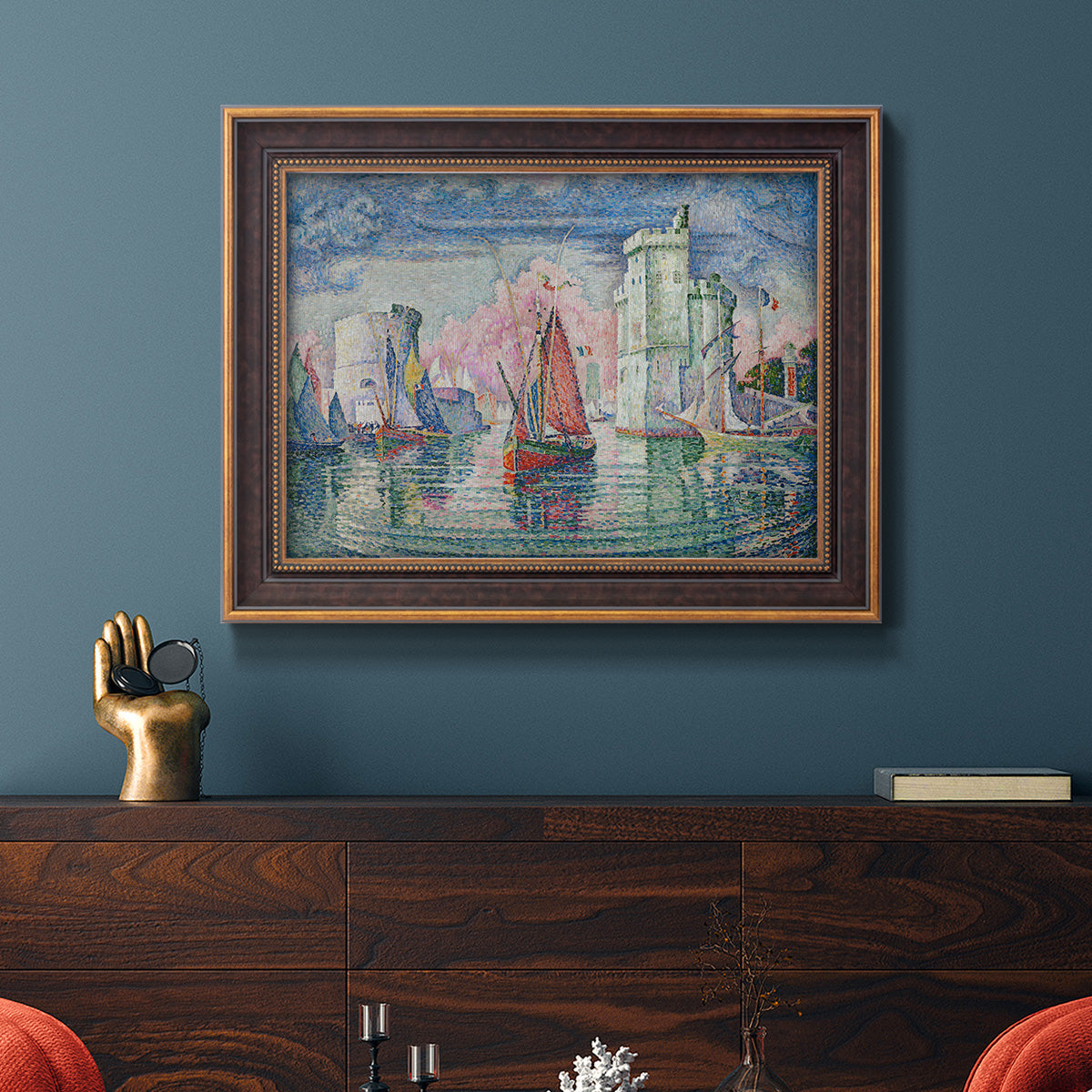 Impressionist harbor scene by Paul Signac in an ornate bronzed mahogany wood frame displayed in a dark-toned interior setting.