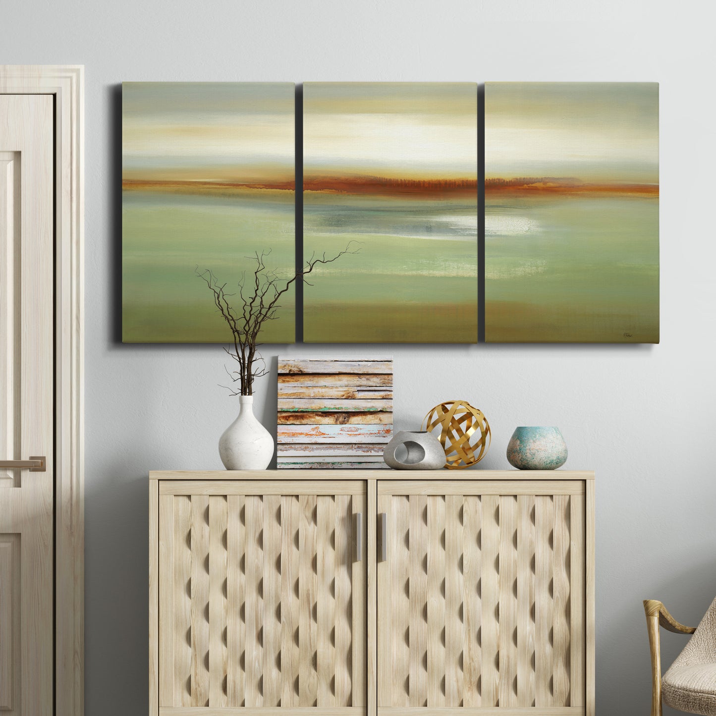Three-panel canvas wall art featuring green focused abstract color vision, displayed above a cabinet in an entryway.