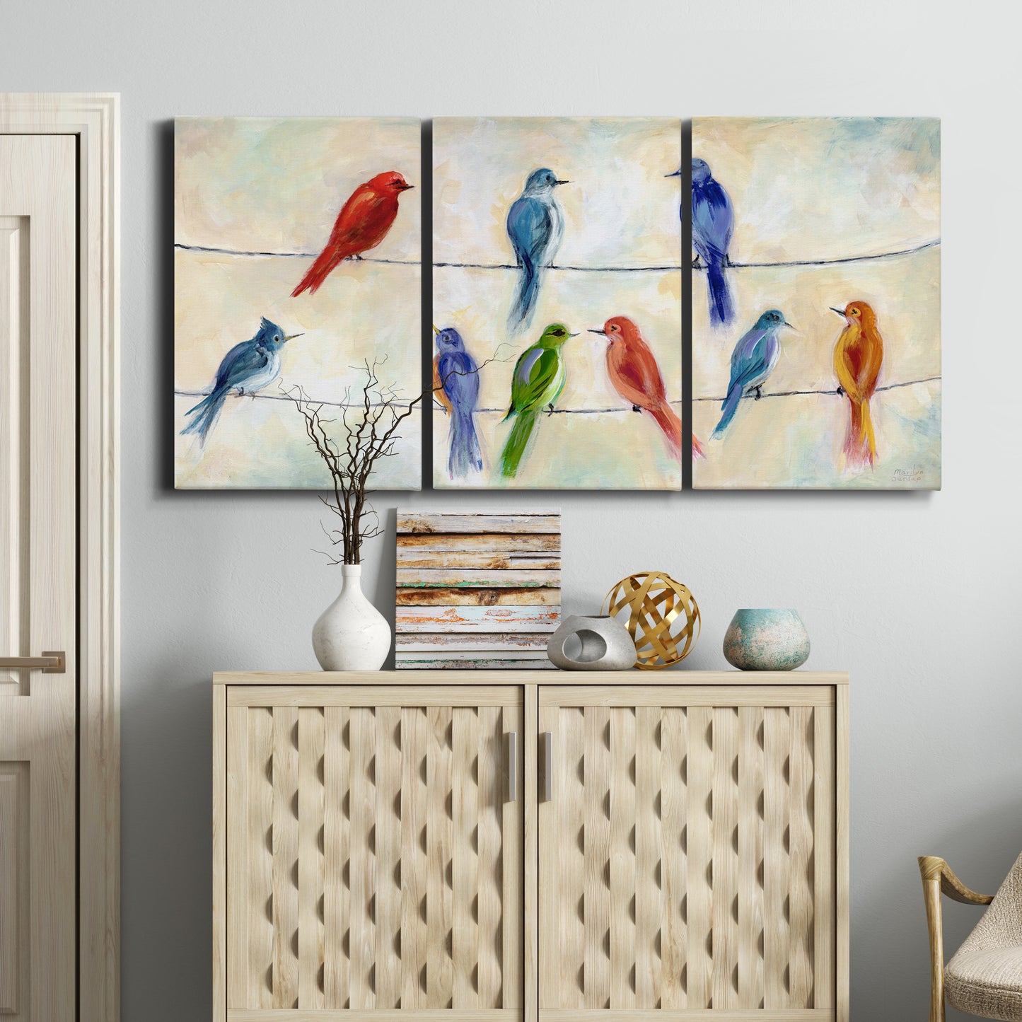 Three-panel canvas wall art featuring whimsical animal chatter illustration, displayed above a cabinet in an entryway.