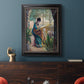 Impressionist portrait of Madame Monet sewing by Claude Monet in an ornate black frame with gilded inner detail displayed in a dark-toned interior setting.