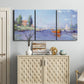 Three-panel canvas wall art featuring river flowing past riverside town, displayed above a cabinet in an entryway.