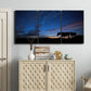 Three-panel canvas wall art featuring resting animals in open field, displayed above a cabinet in an entryway.